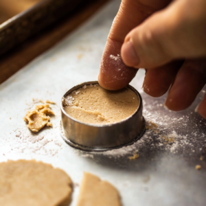 Homemade Mazapán candy made with peanuts and sugar, displayed on a rustic wooden surface. Traditional Mexican sweet recipe, easy and simple to make, perfect for holidays or gifting.