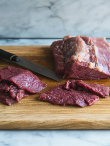 slicing the meat for beef jerky