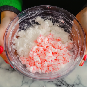 Adding color and scent to cloud slime during the DIY process for a fun, personalized touch.