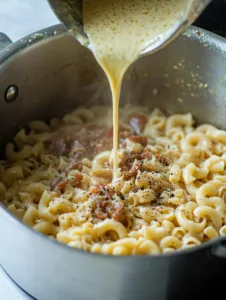 Rich and creamy sauce being prepared for Cavatappi pasta, made with garlic, cream, and Parmesan cheese.