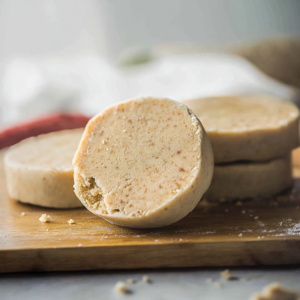 Homemade Mazapán candy made with peanuts and sugar, displayed on a rustic wooden surface. Traditional Mexican sweet recipe, easy and simple to make, perfect for holidays or gifting.