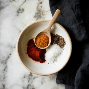 Ingredients for homemade chicken taco seasoning including chili powder, cumin, paprika, and more.