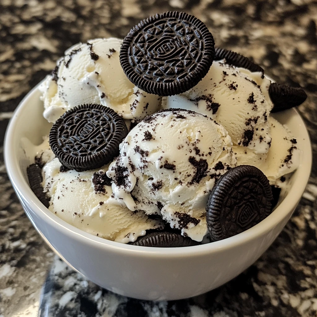 A bowl of homemade Oreo ice cream, garnished with crushed Oreos on top.