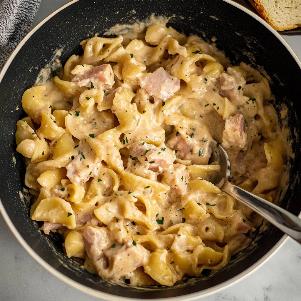 Closeup of homemade Tuna Helper pasta with creamy sauce and fresh parsley