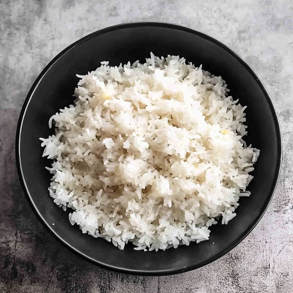 Serving spoon lifting jasmine rice from the Instant Pot, showcasing the fluffy texture.