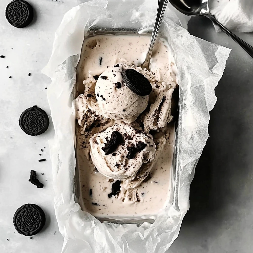 Mixing crushed Oreos into the creamy no-churn ice cream base for homemade Oreo ice cream.