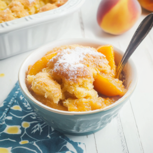 Peach Cobbler with a golden cake mix topping and sweet peach filling, freshly baked and ready to serve.