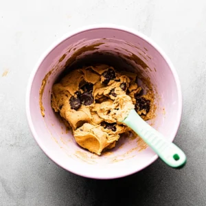 Mixing ingredients for small batch chocolate chip cookies in a bowl.